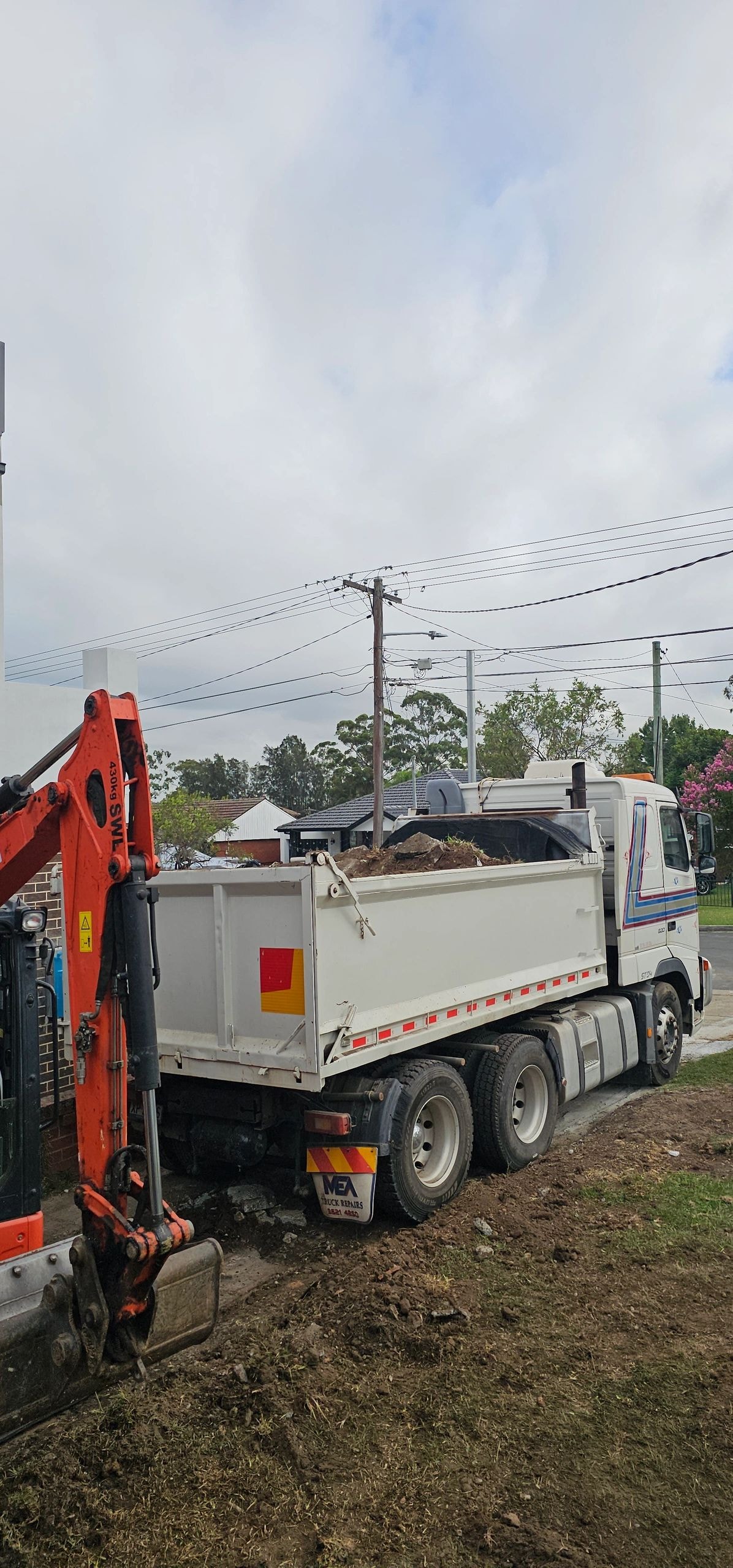 Dump truck loaded with soil on residential site