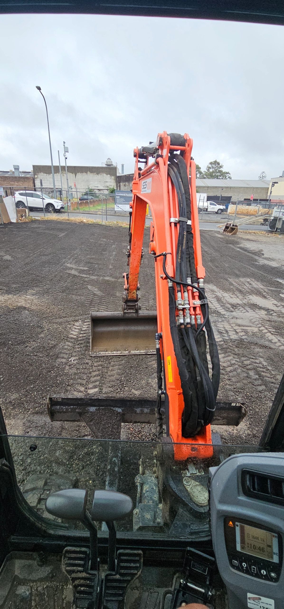 Orange mini excavator at construction yard